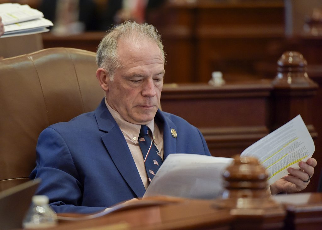 Wilcox reading a bill.